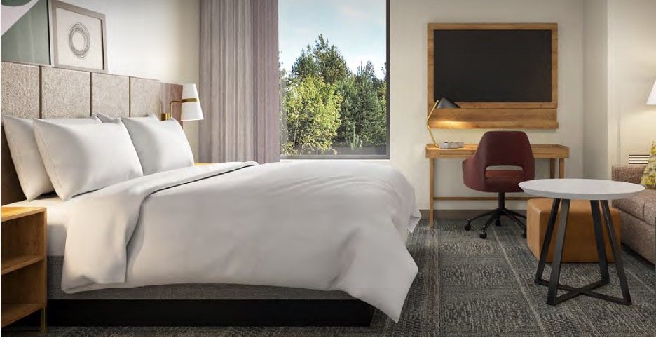 Rendering of a hotel suite with a bed and desk